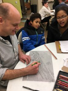 Ambassador Corrine Brooks and Green Team Member Martin work with a designer to sketch out additions to a local playground. 